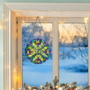 12"H Stained Glass Halston Window Panel in front of a window with a snowy landscape view.