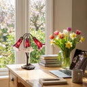 16"H Hand Blown Mercury Glass 3 Lily Downlight Accent Lamp on a home office desk with books, laptop, mug, and flowers by a window.