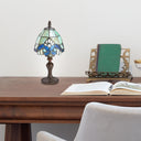 Set of 4 Family Favorites Tiffany Style Stained Glass Mini Accent Lamps on a wooden table with books and an open book
