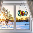 9.5"H Birds in Love Stained Glass Window Panel hanging in front of a snowy landscape with a sunset.