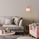 63"H Rowan Globe Shade Floor Lamp in a modern living room with a gray sofa and pink armchair