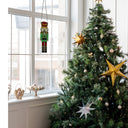 14"H Hans the Holiday Nutcracker Stained Glass Window Panel in a holiday setting