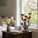 20"H Hand Blown Glass 5 Calla Lily Uplight Accent Lamp on a decorative table with a vase of flowers and books in a room with a window.