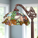 60" H Victoria Brown Candlestick Base with Stained Glass Dome Shade Floor Lamp in a room with windows.