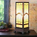 17"H Tiffany Style Stained Glass Rustic Hurricane Lamp on a wooden table with a brick wall background