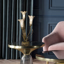 21.75"H Hand Blown Mercury Glass 3 Lily Uplight Accent Lamp on a round gold table with a pink chair and dark blue wall in the background