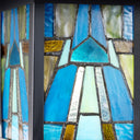 River of Goods Aqua and Amber Stained Glass and Black 1-Light Outdoor Lantern Wall Sconce