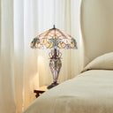 24.5" H Halston Double Lit Ivory Bowl Shade Stained Glass Table Lamp on a side table with curtains in the background
