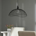 19.75" 1-Light Brigitte Pendant Light Black hanging above a white chair and table against a gray wall.